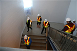 Construction crew walking down a flight of stairs
