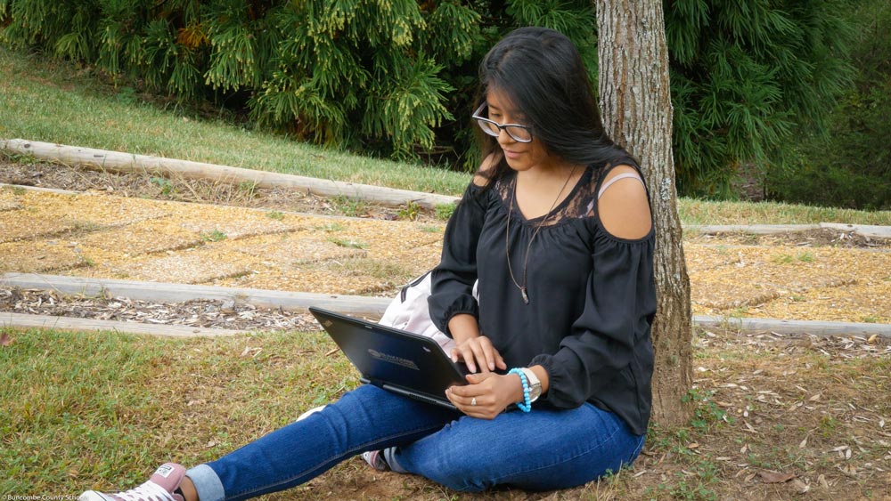 A student studies on a college campus as part of a BCS high school program.