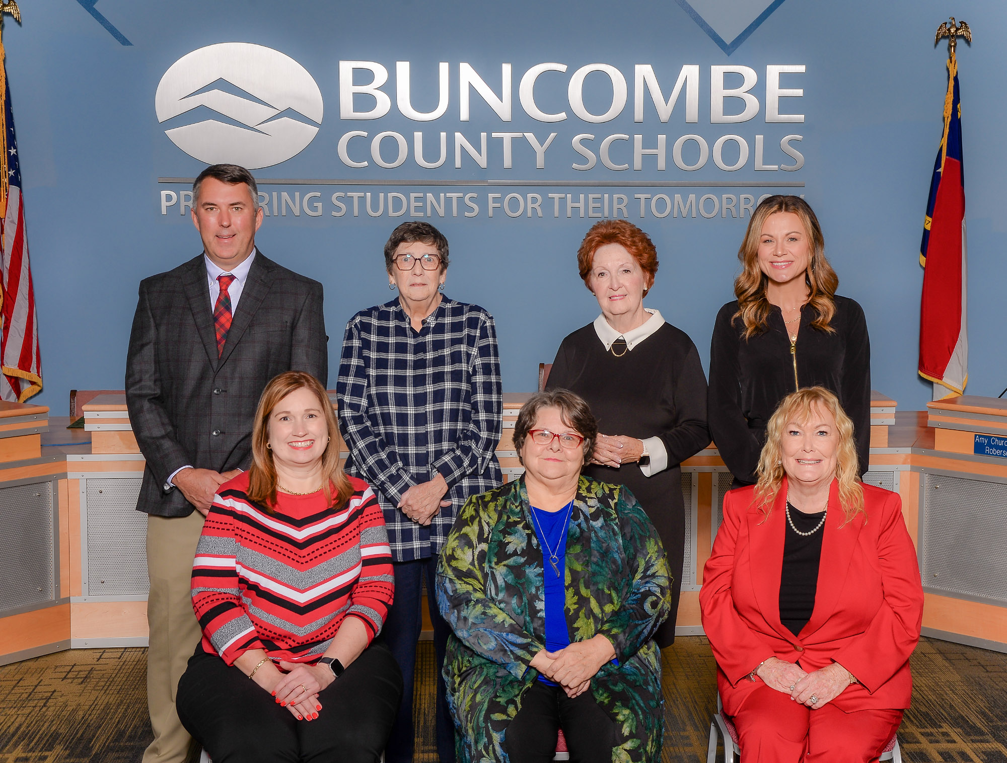 The Buncombe County Board of Education poses in their board meeting room.