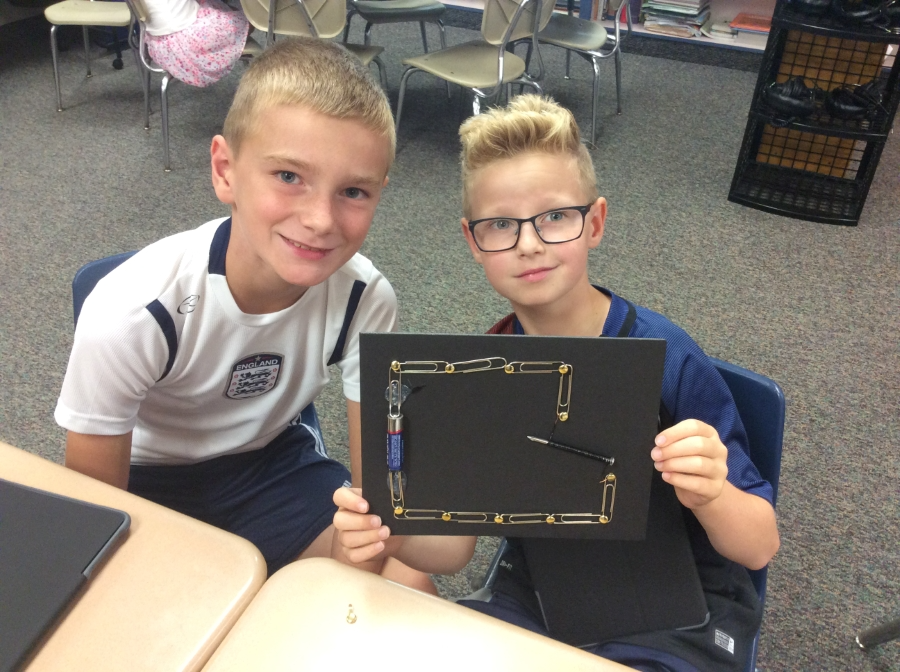 Two elementary students showing off their STEM project