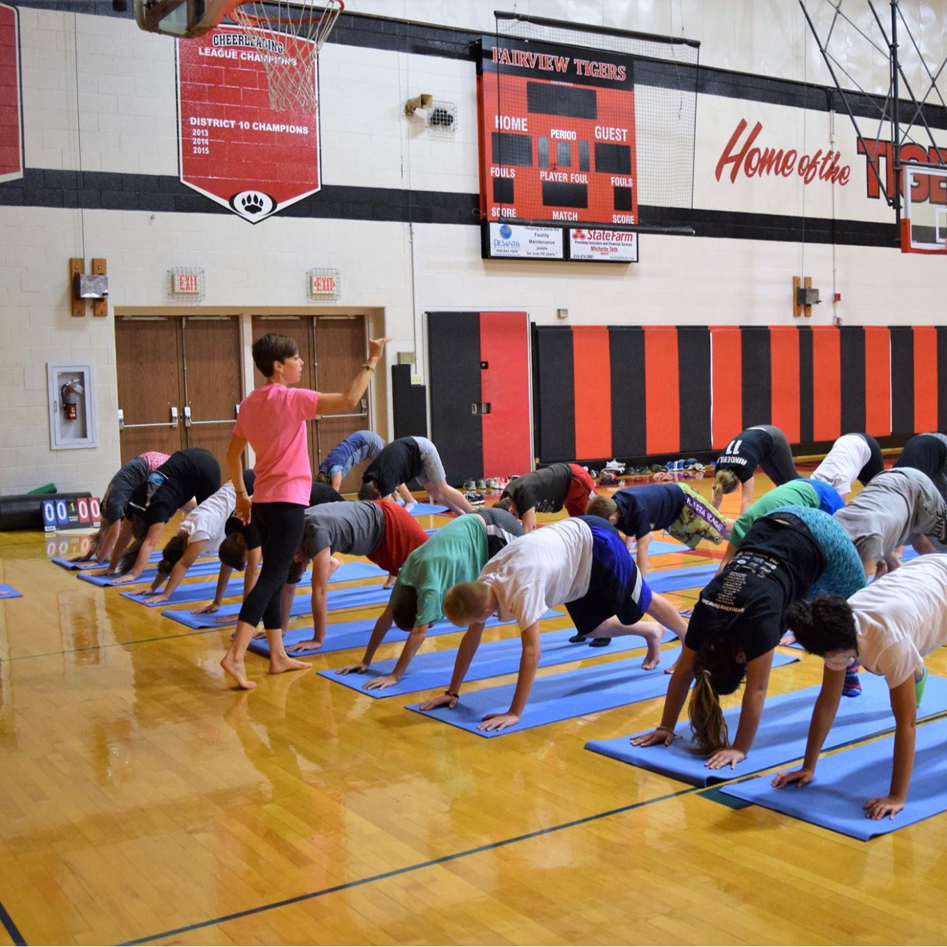 Students practicing their yoga poses on the newly purchased matts