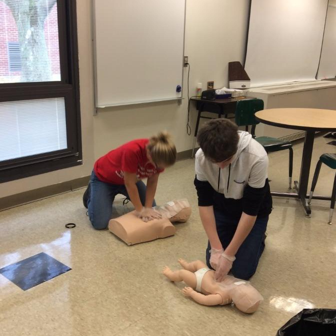 8th graders practicing CPR in class