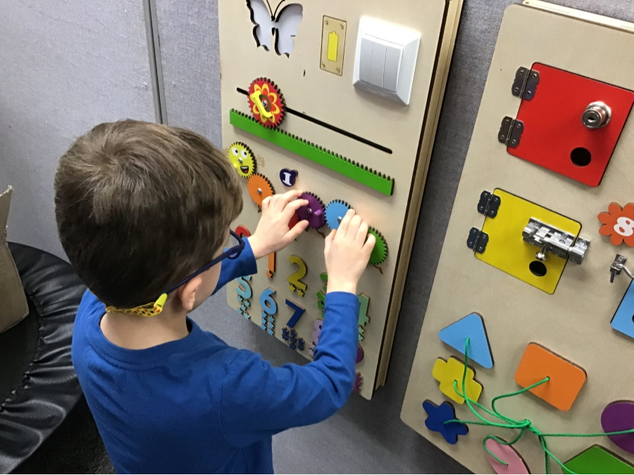 Elementary student using the Sensory Wall
