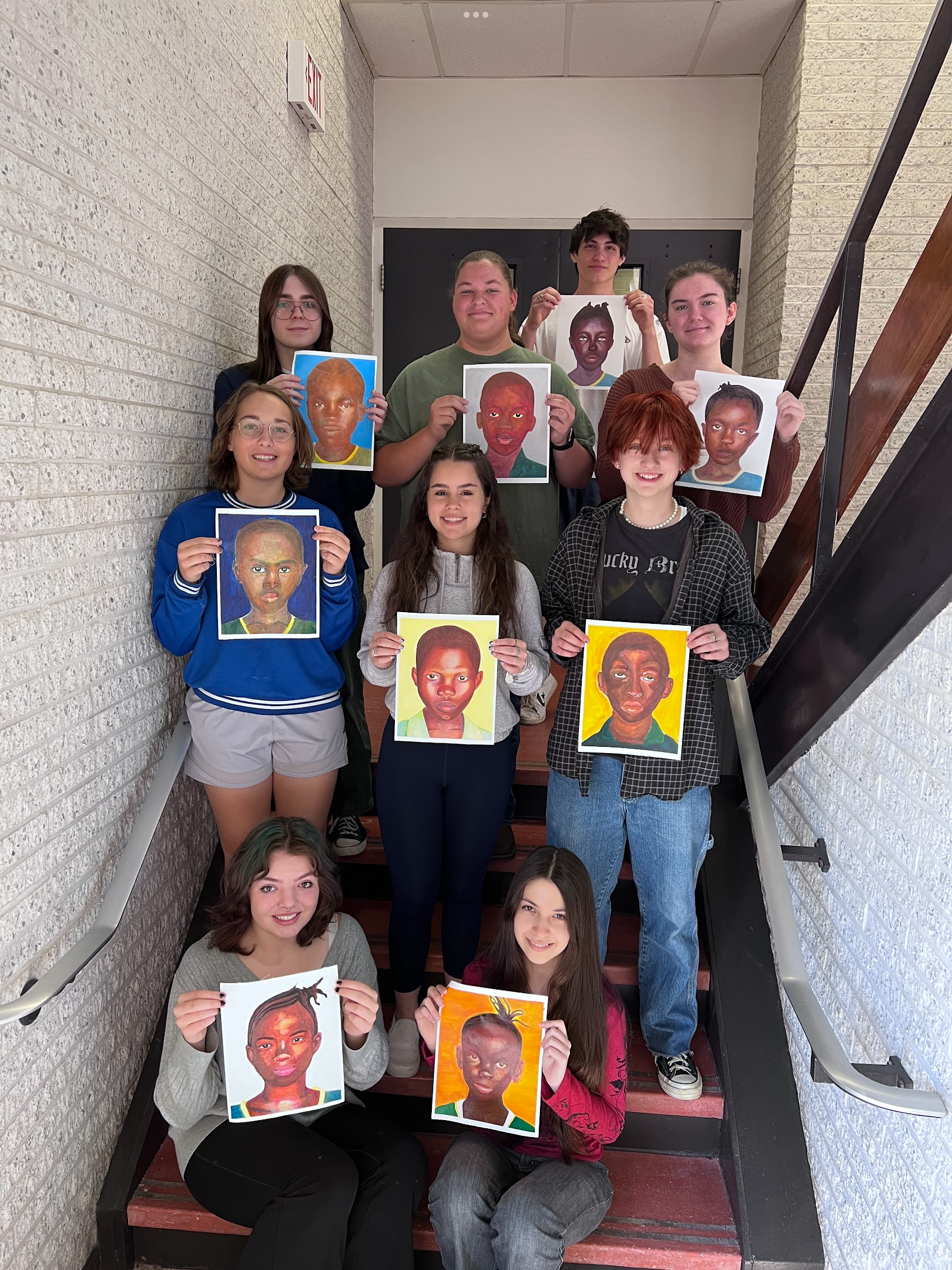 High school students with their painted portraits