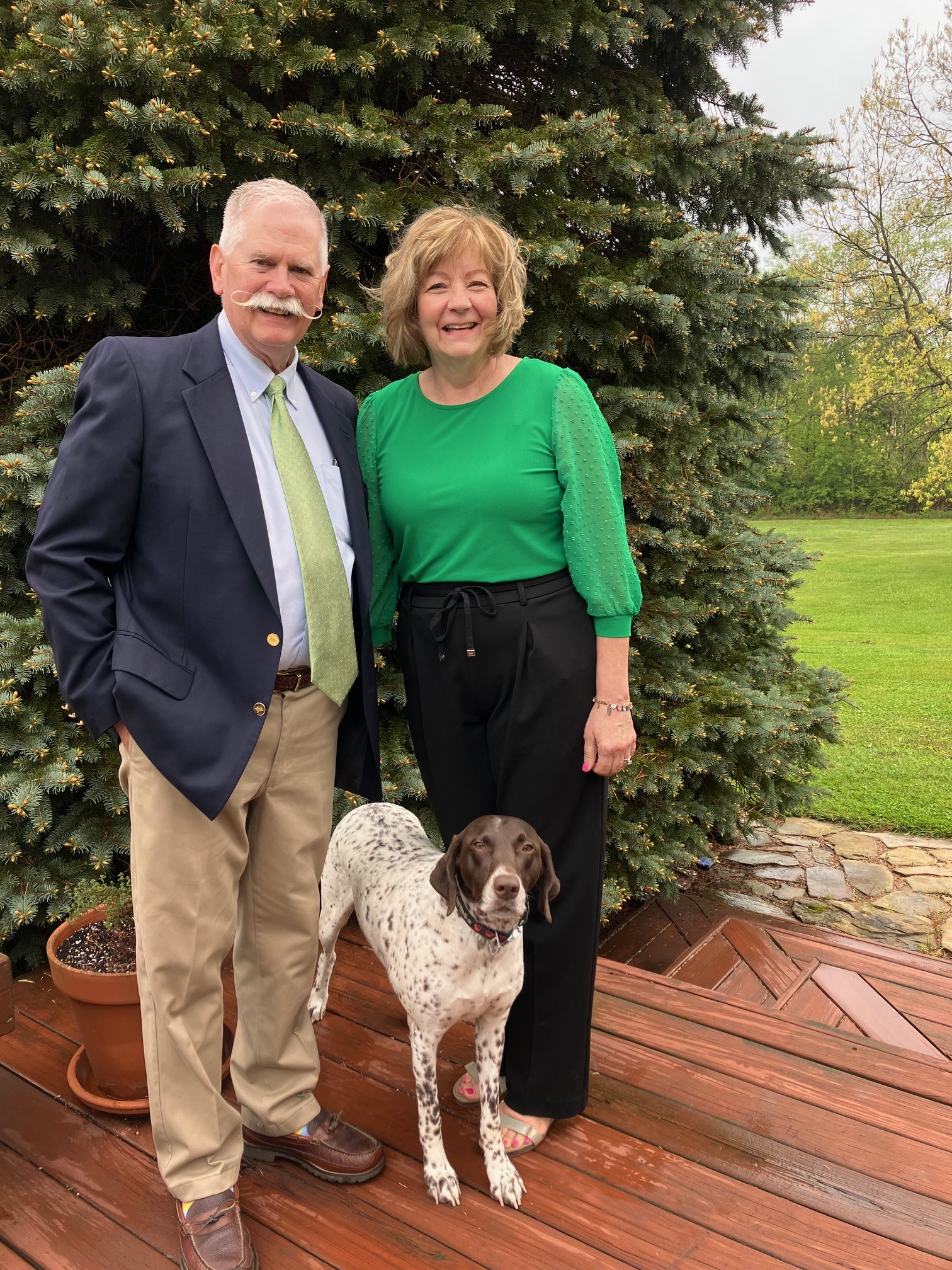 Deb and Andy Foyle with their dog posing outside