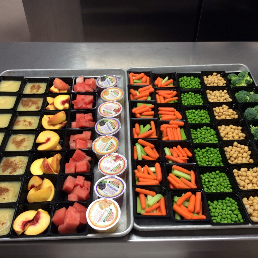 Trays of food with veggies and fruits