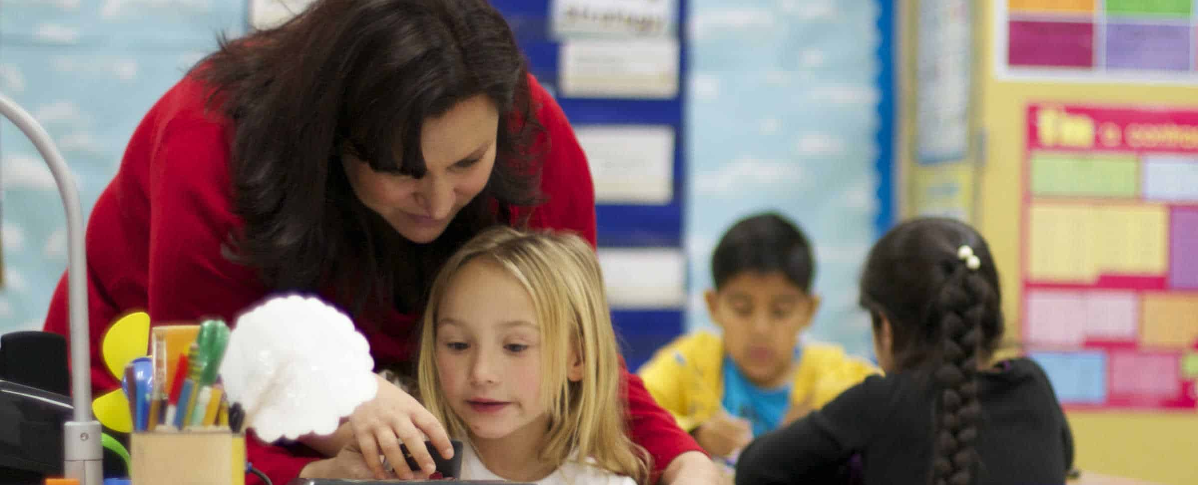 Teacher with student in class