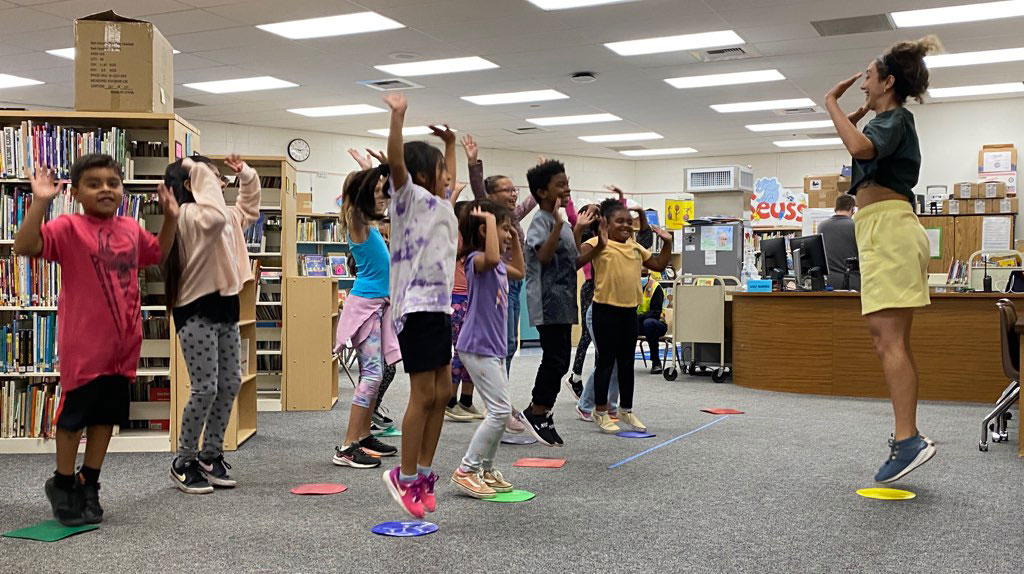 Classroom of students  jumping