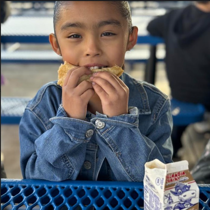 Student eating Breakfast taco 