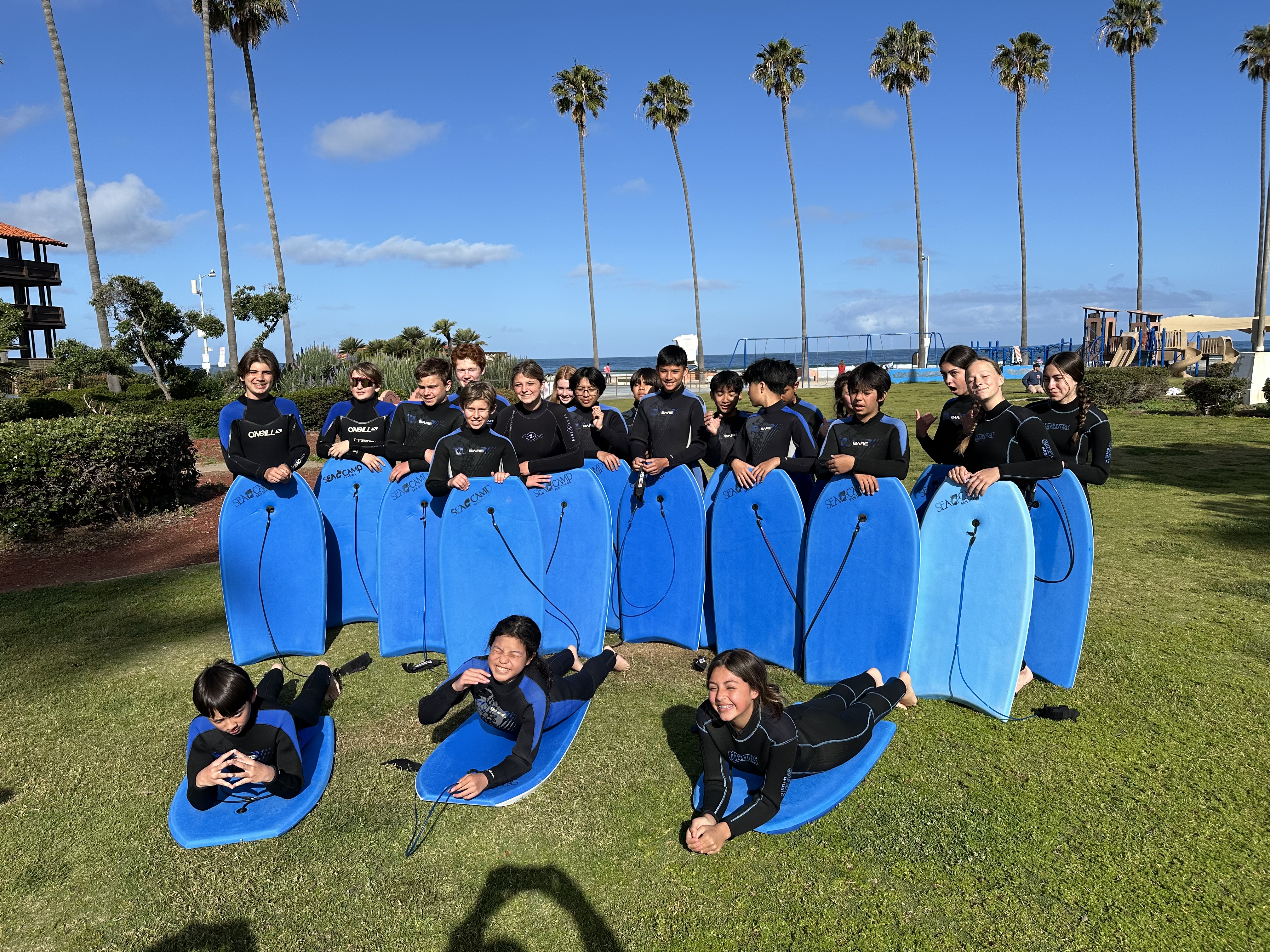 students at seacamp holding boogie boards and wearing wetsuits