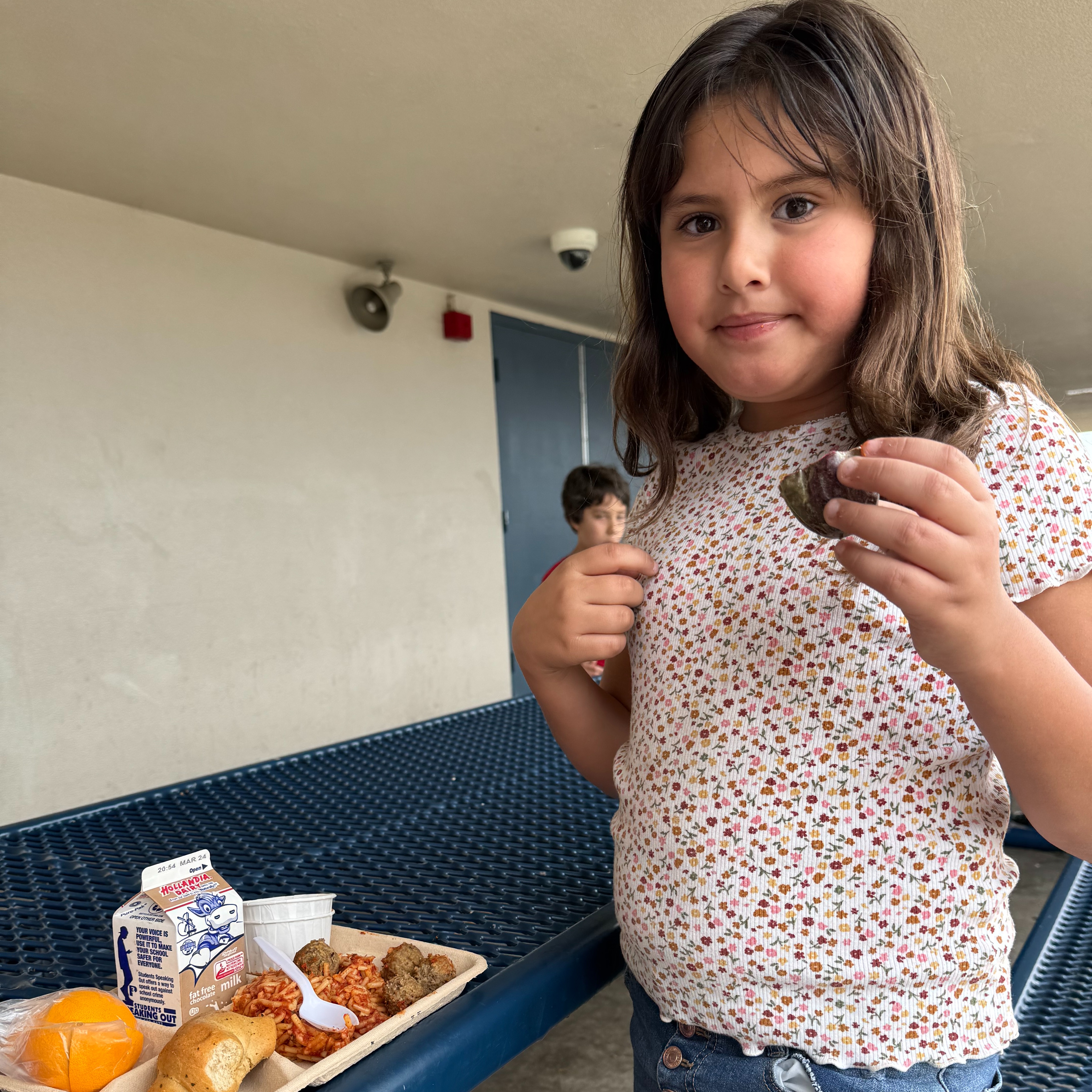 Student at Rose taste testing passion fruit