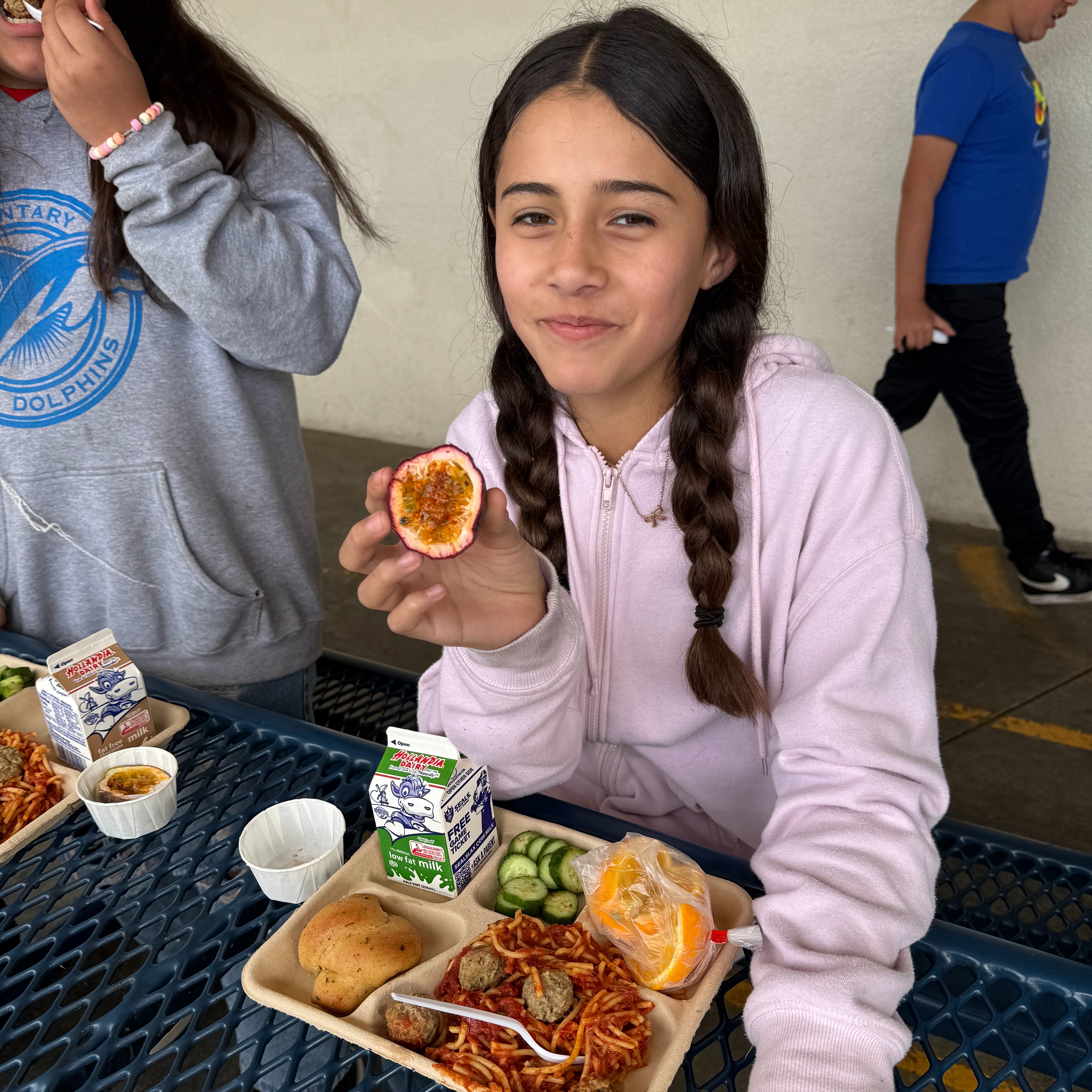 Student at Rose taste testing passion fruit