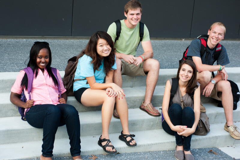 Students sitting together outside building