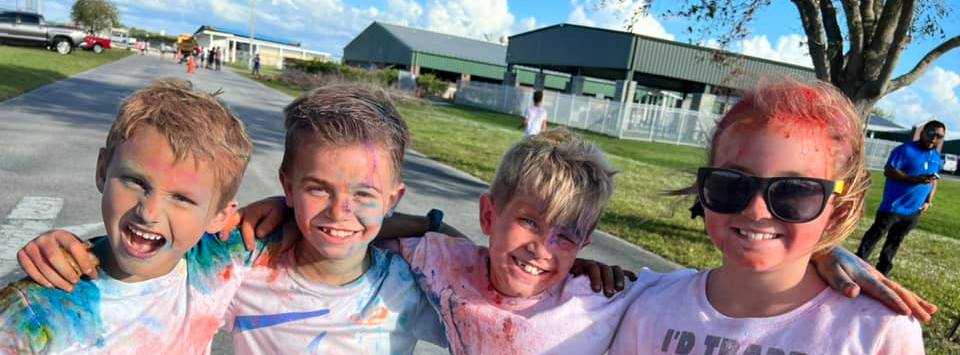kids covered in colored powder after a race 