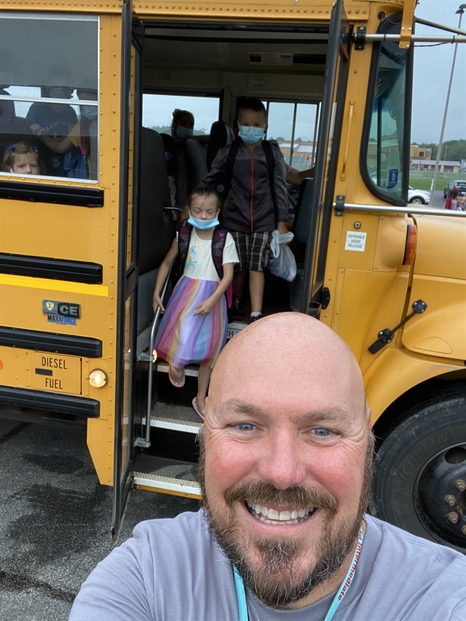 Pictured is Principal Brad Targgart welcoming students off the bus at arrival.