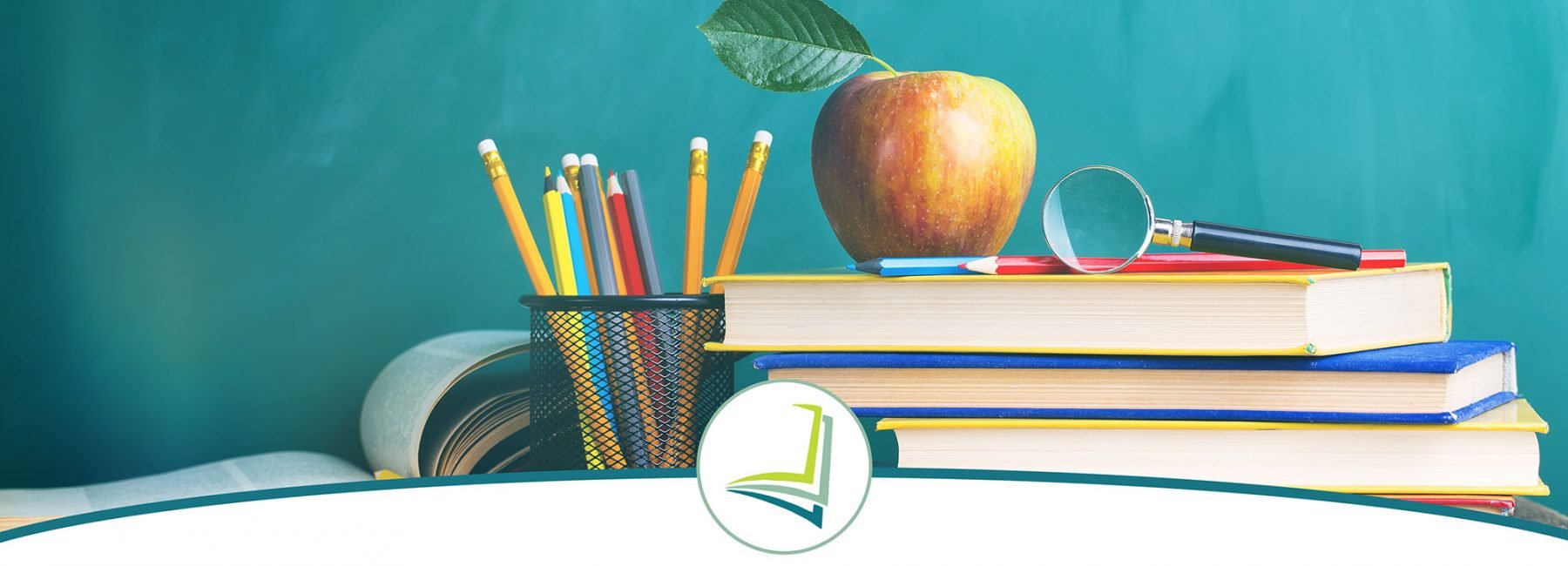 Pile of books with an apple on top and a bunch of color pencils
