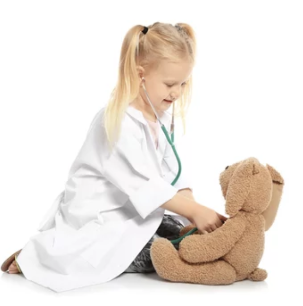 Girl pretending to be a doctor taking care of a bear