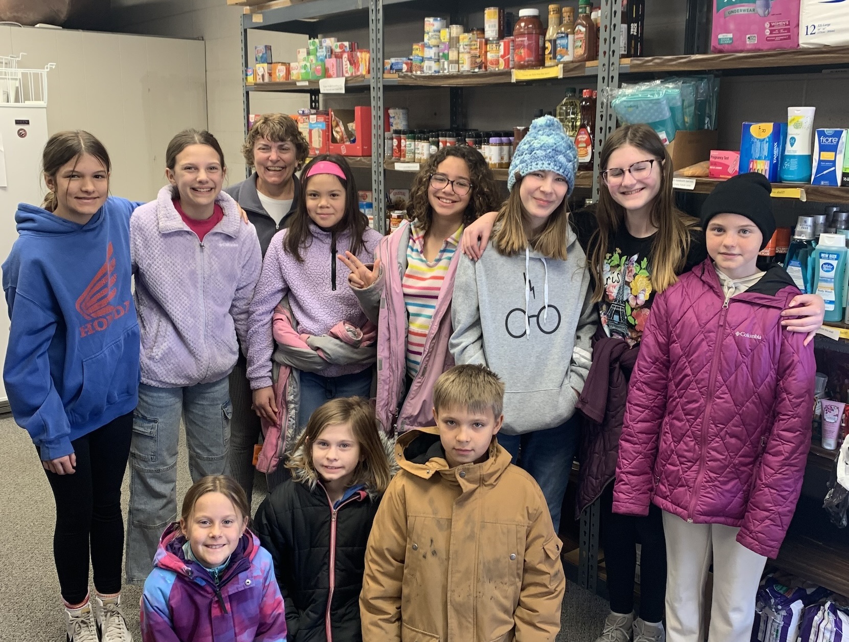 students at food shelf with donations