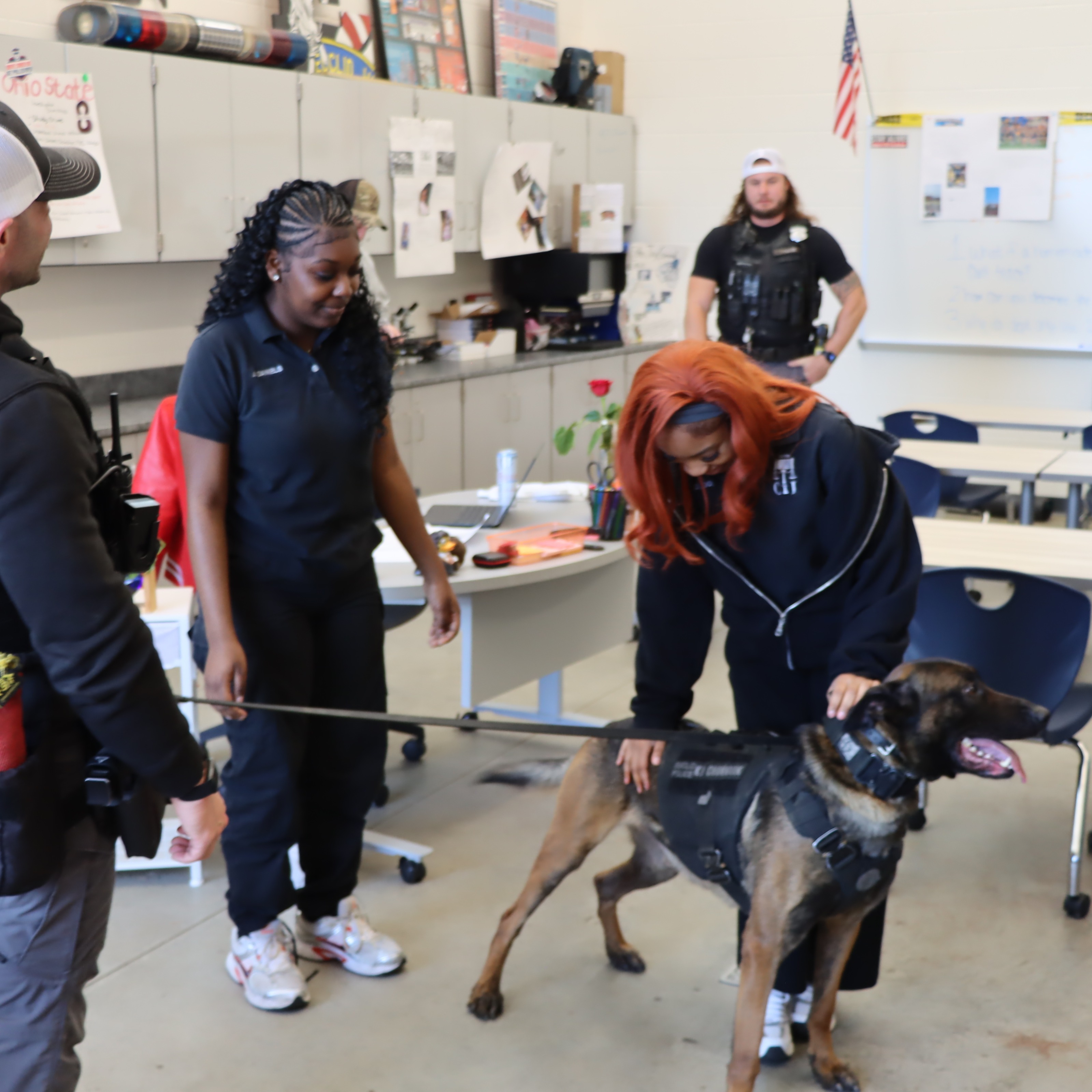 Two Criminal Justice CTE students interact with K-9 Officer Chinook during a demonstration with Euclid Police.