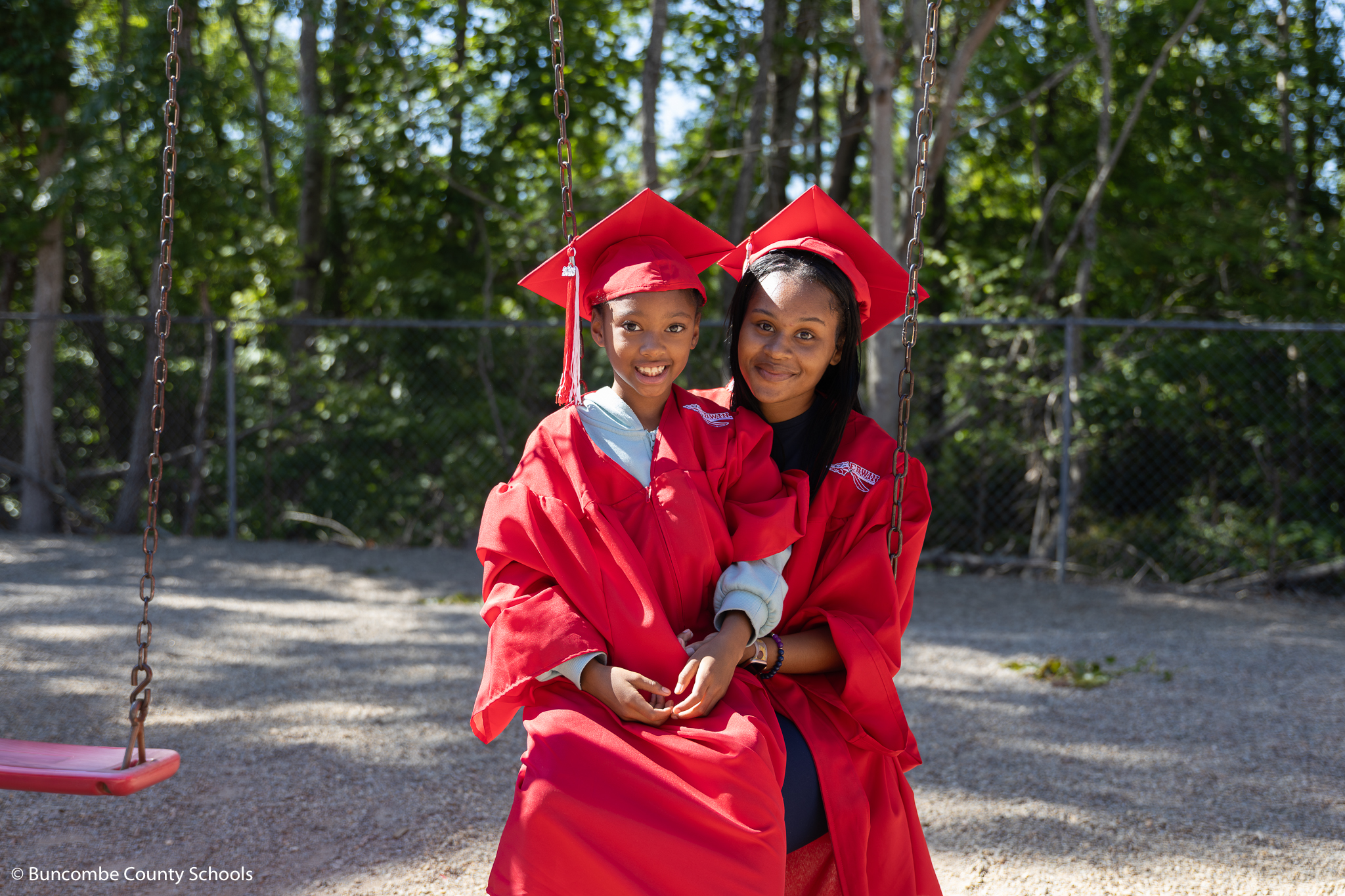 Erwin high senior in a cap and gown with an Emma student in a cap and gown. 