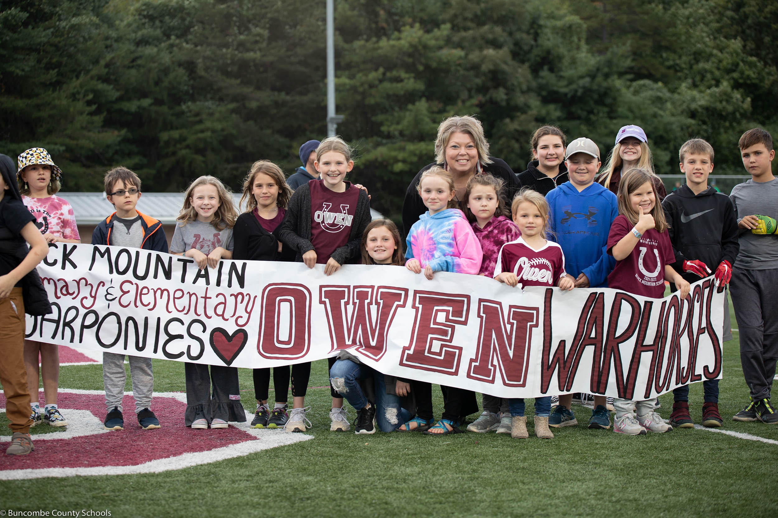 Principal Kelly Owen with students at an Owen High School football game.