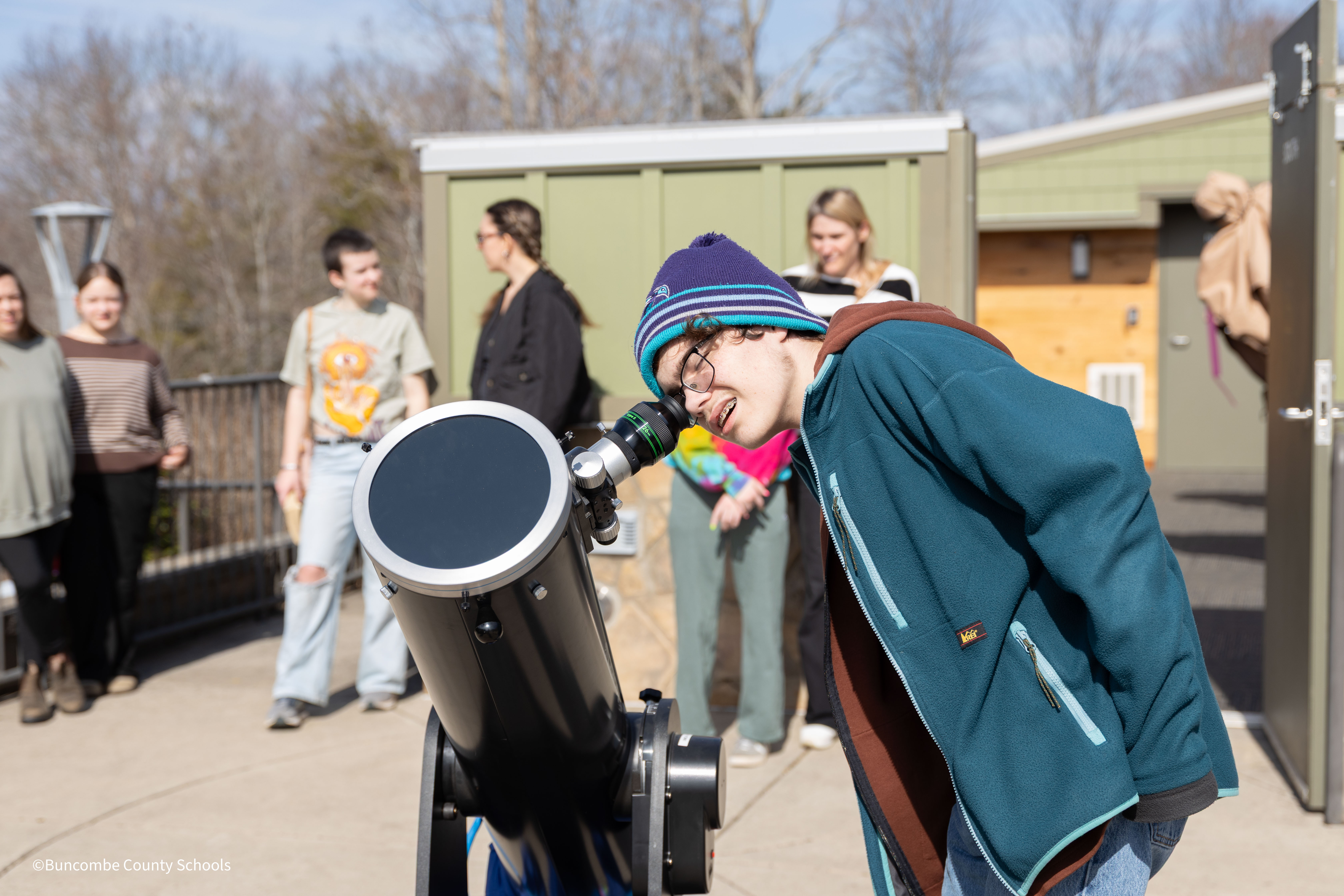 Student looking through telescope