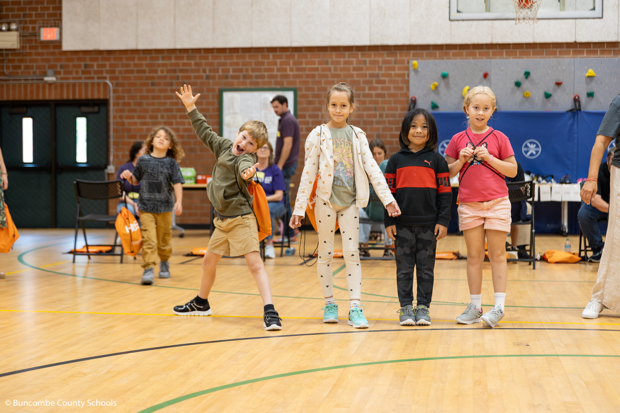Group of students showing off their new shoes given to them by Samaritan's Feet. 