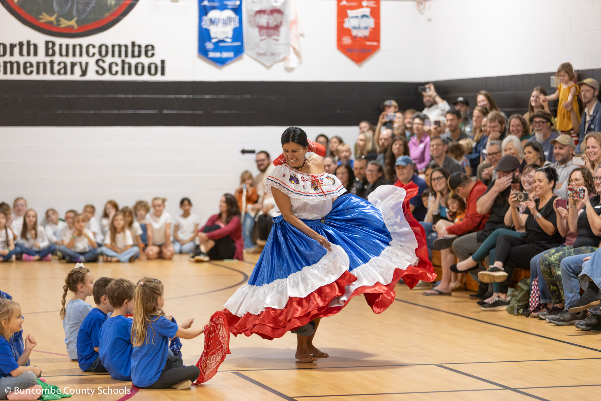 Teacher dressed up for Hispanic Heritage month dancing in the gym. 
