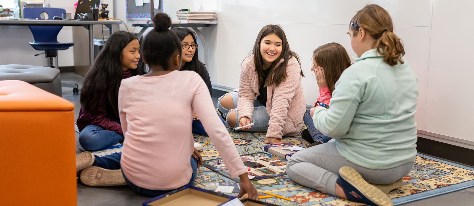 Students play a board game during Club Day.