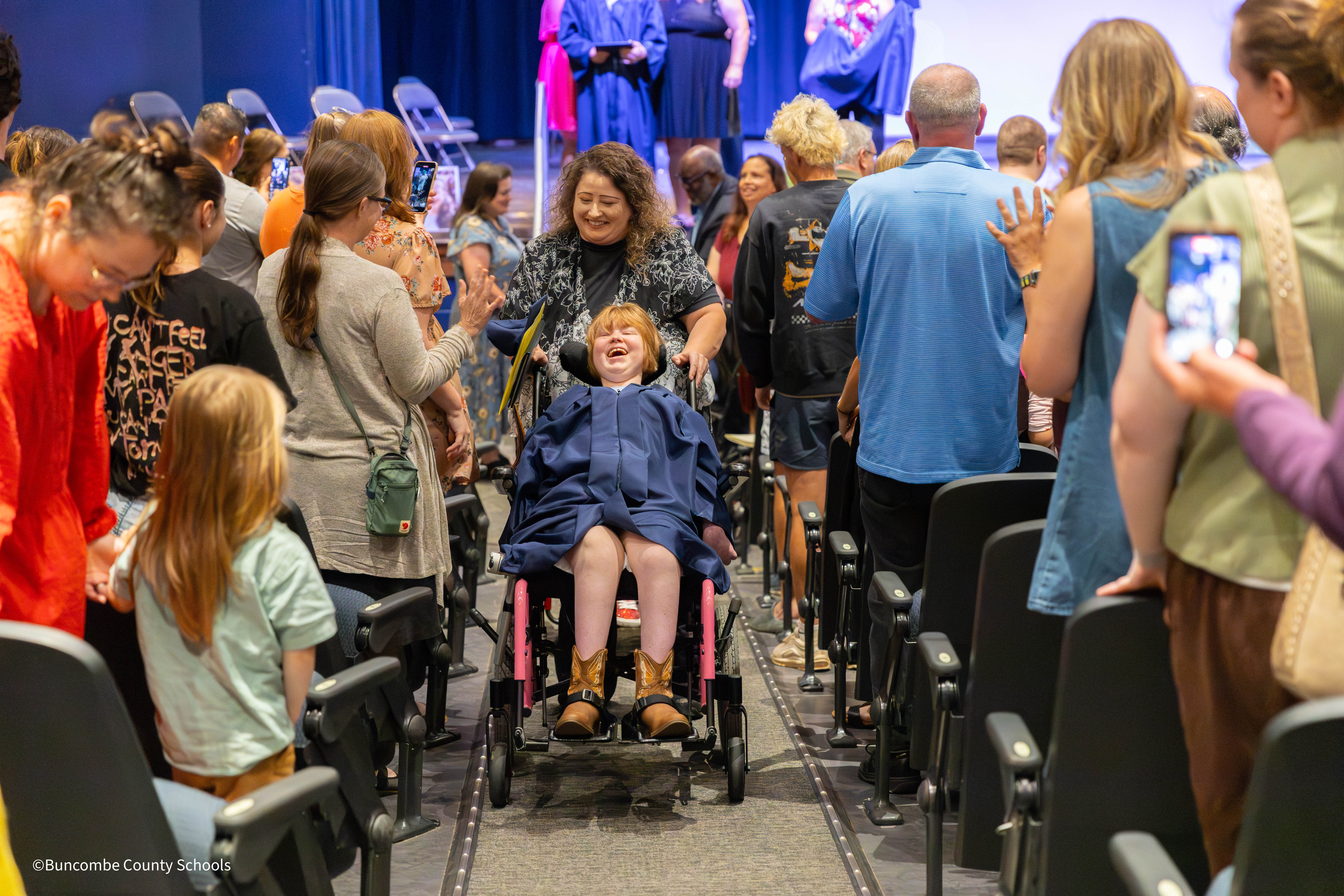 Student exiting auditorium after graduation