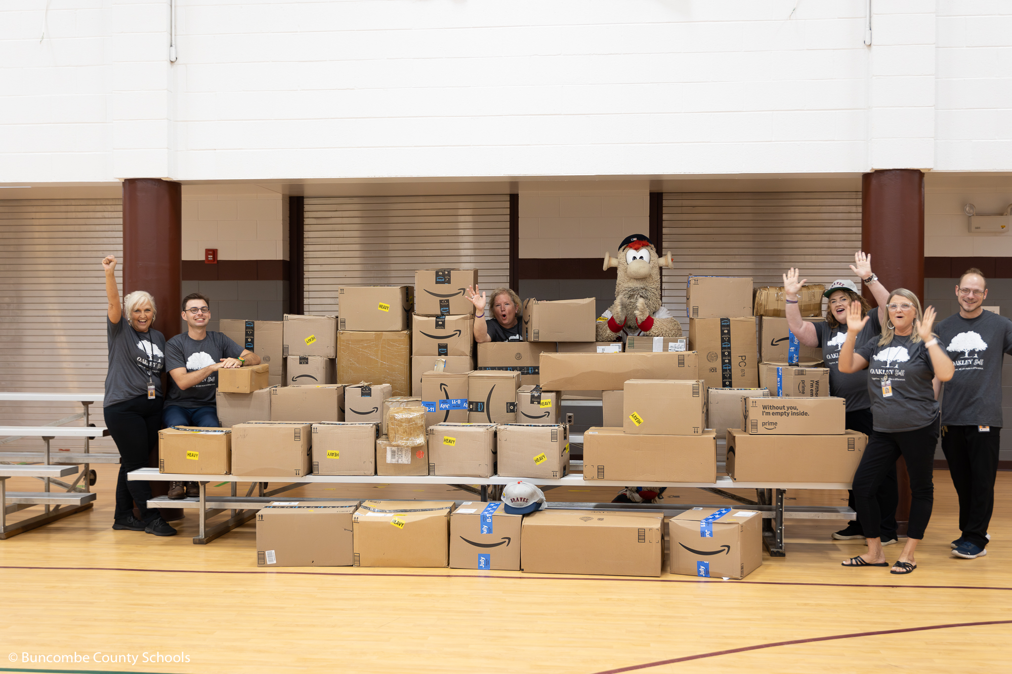 Atlanta Brave Mascot Blooper with staff from Oakley and boxes of school supplies the MLB team donated. 