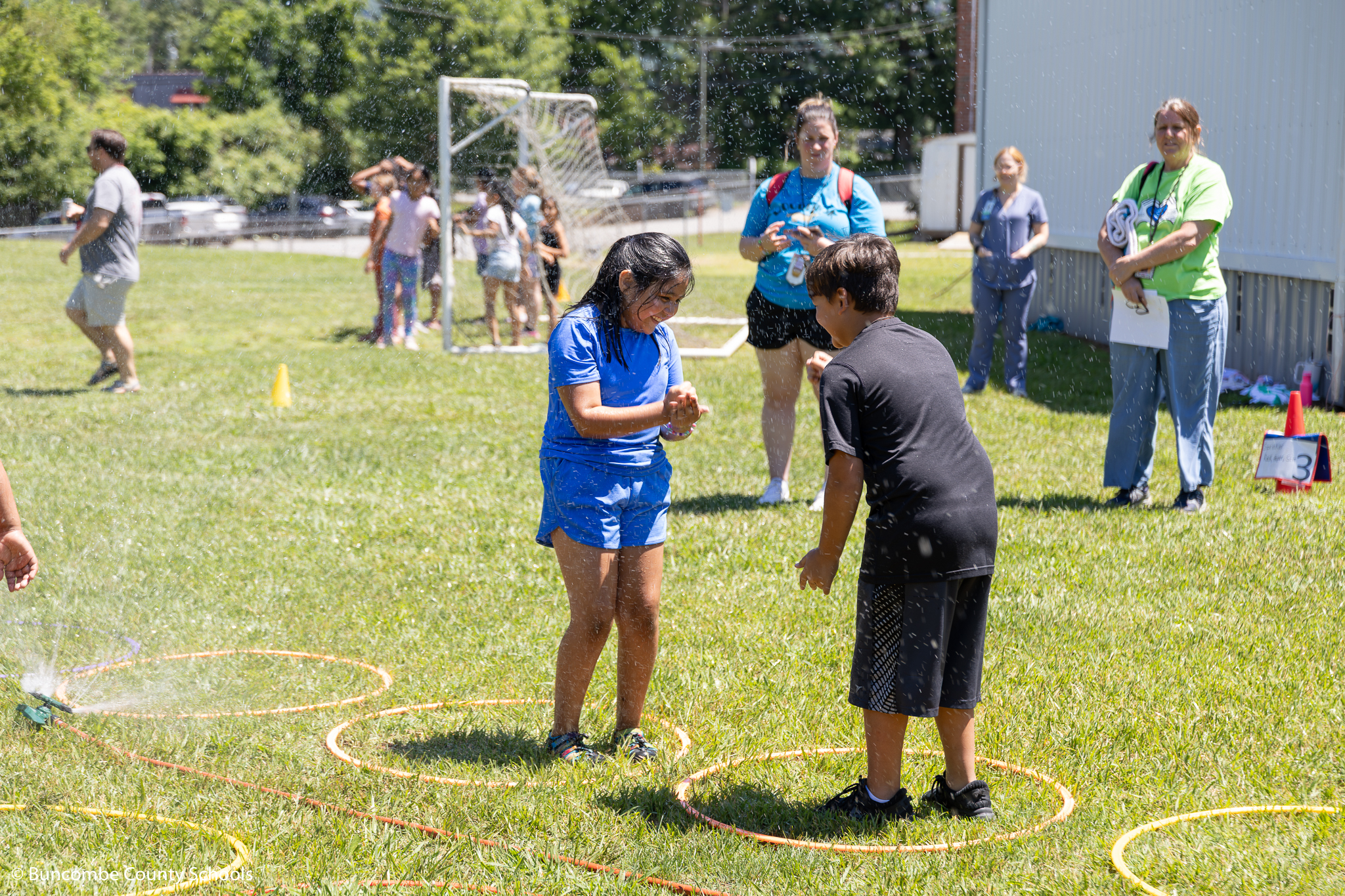 Students playing in water at Field Day. 