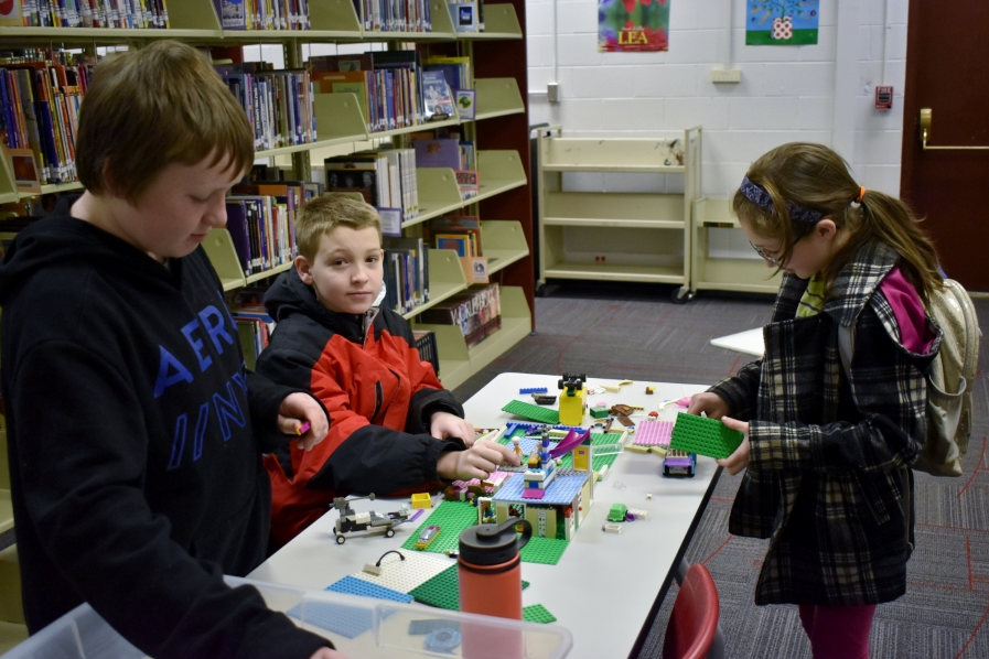 Group of students in the OMS Maker Space playing with legos