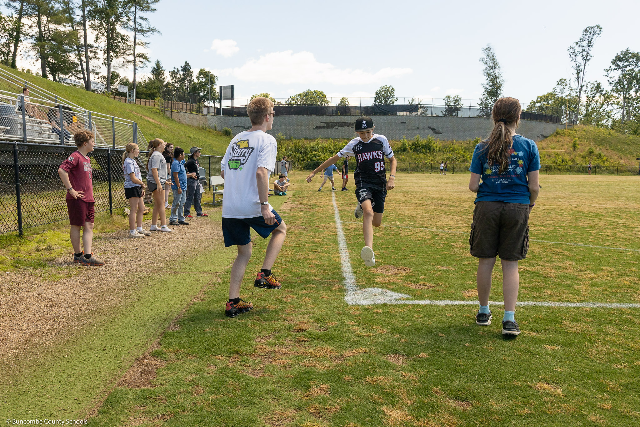 A student makes it to home base during a kickball game.