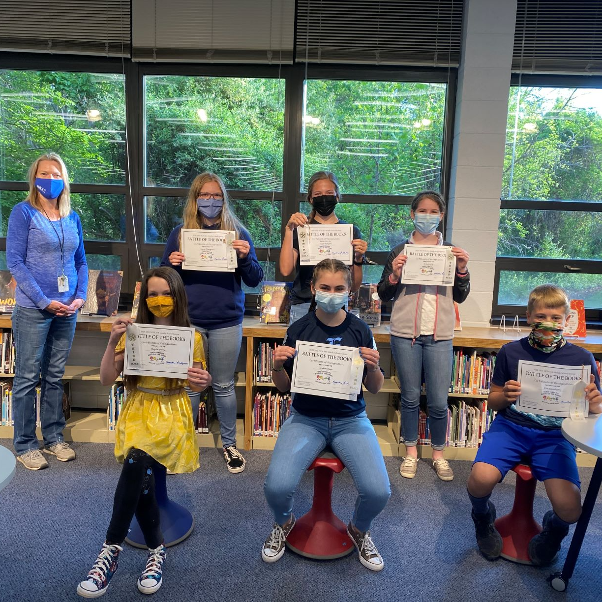 Battle of the Books holding diplomas  at the library
