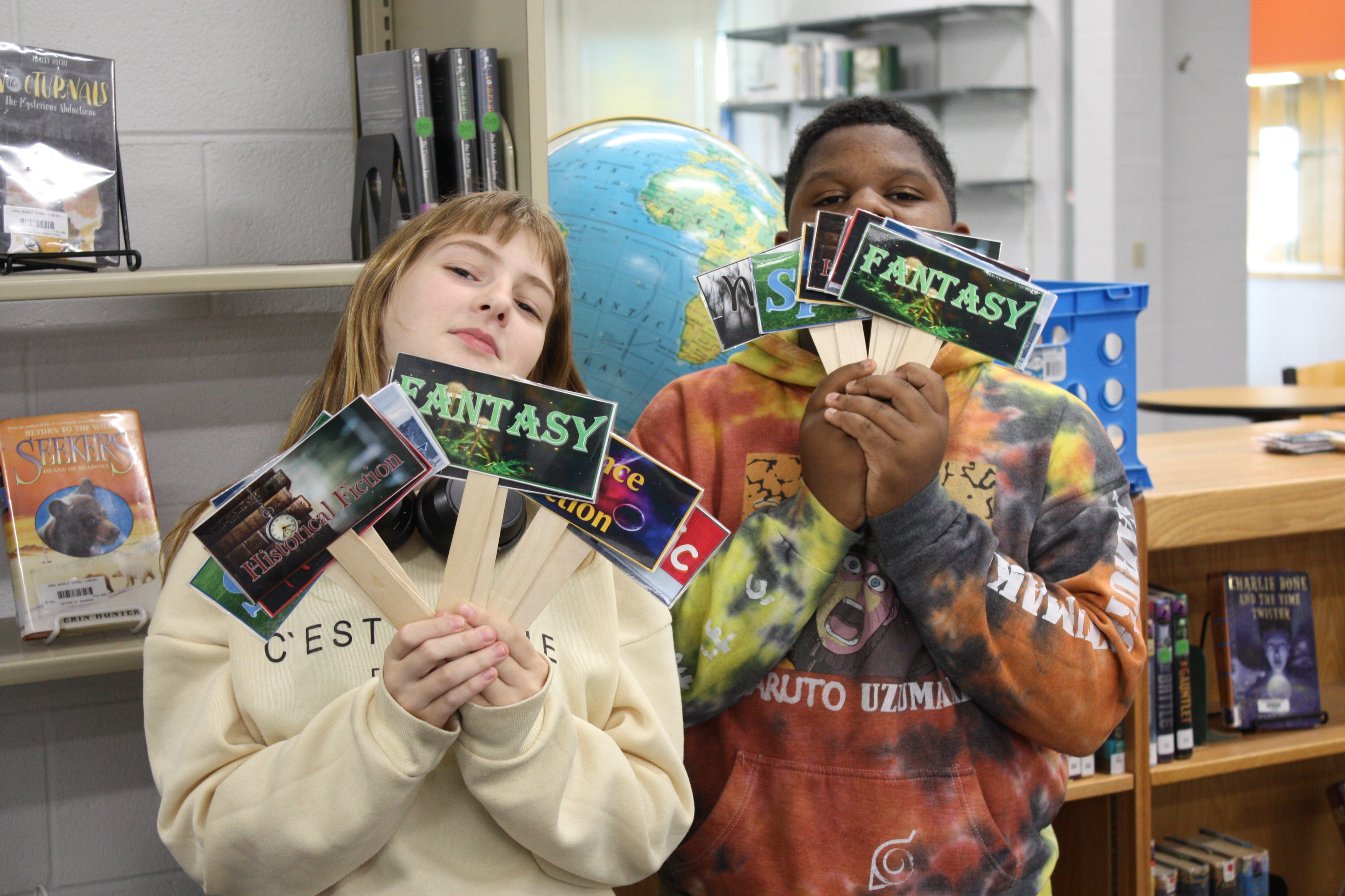 students holding genre signs