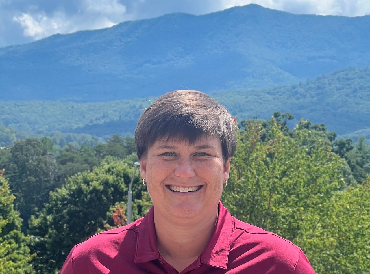 This is an image of Kim Mason in front of the beautiful mountains of the Swannanoa Valley.