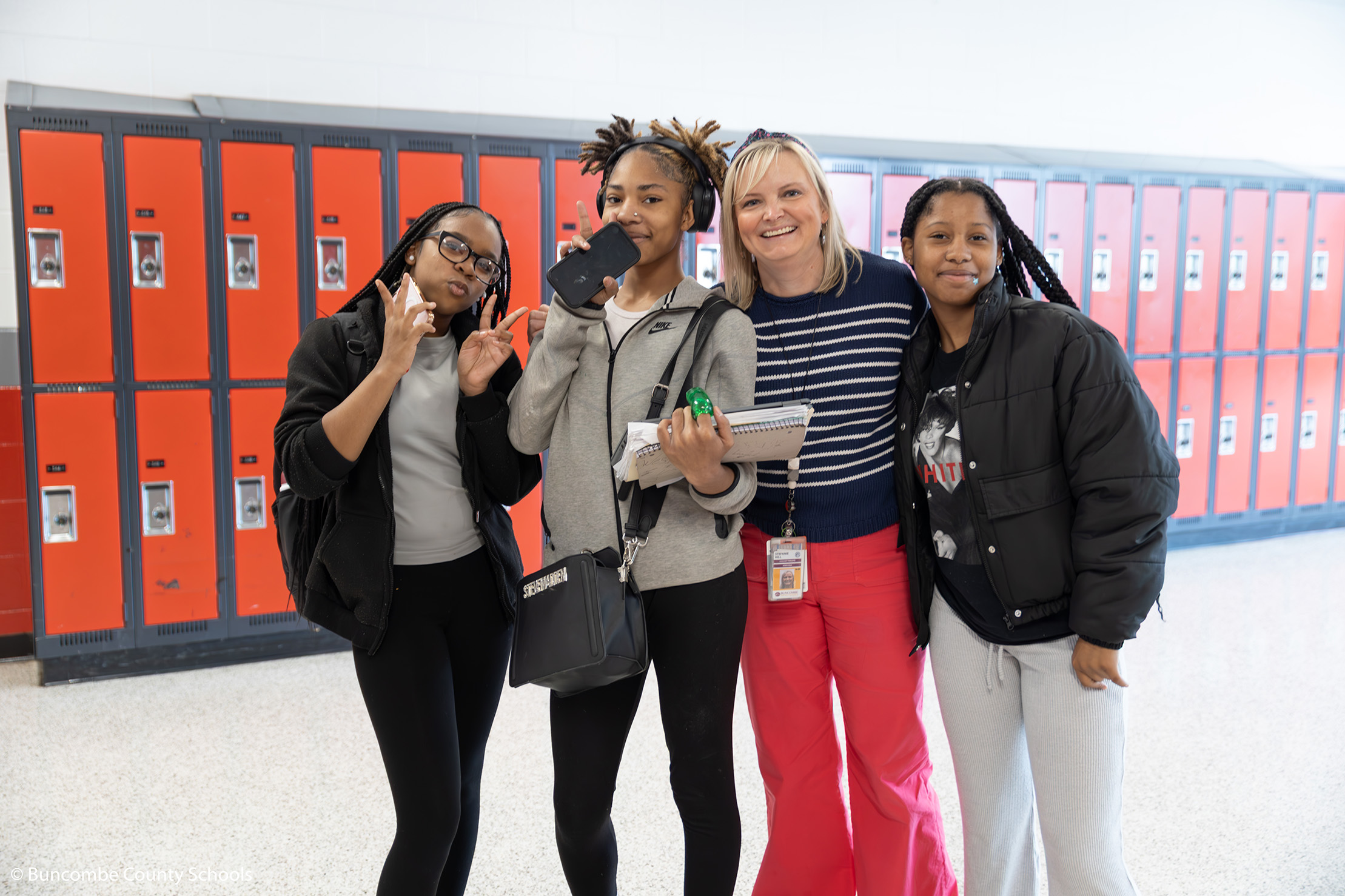 Assistant Principal Stefanie Hill with a group of students smiling for the camera. 
