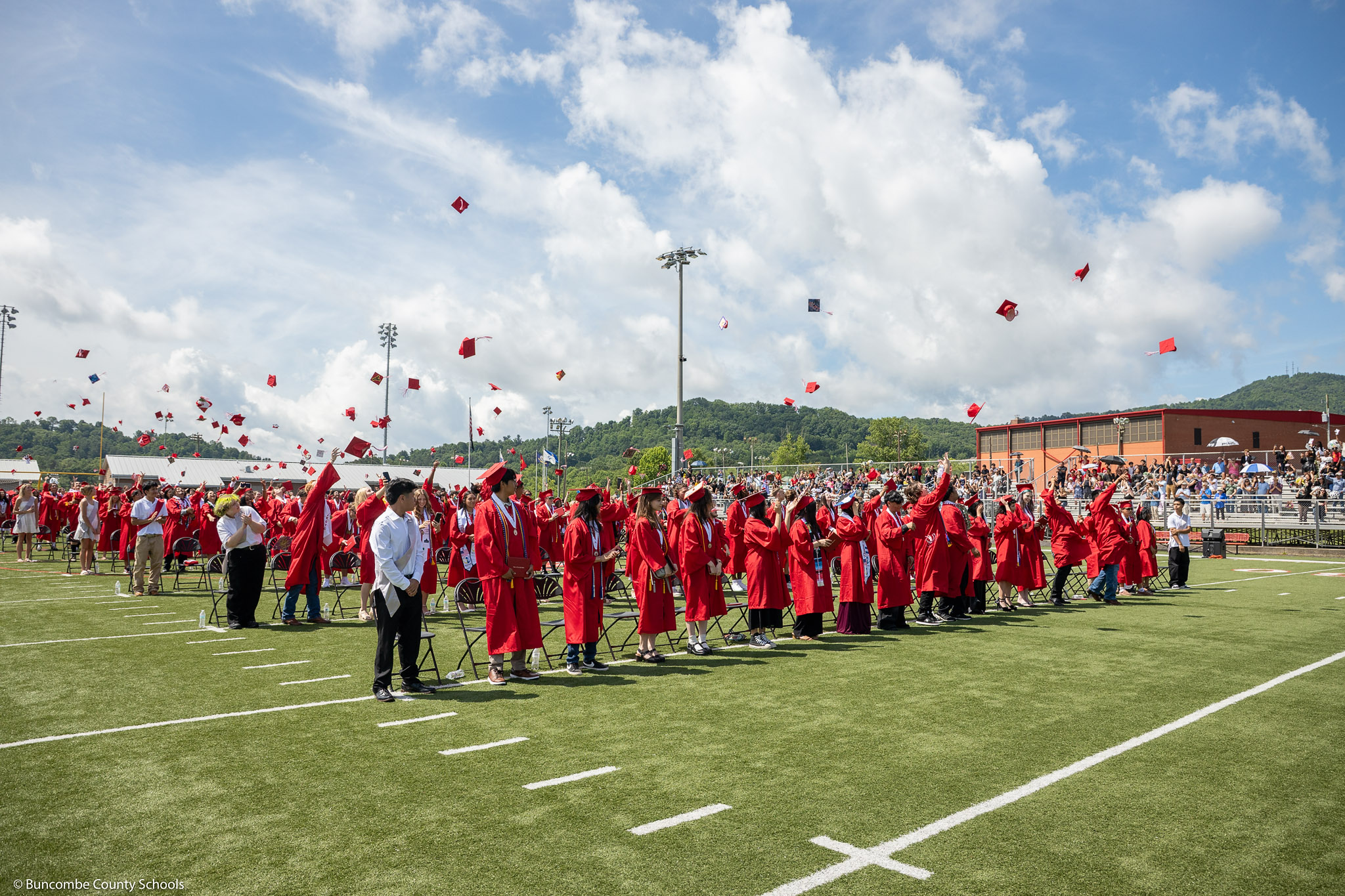2025 Erwin High graduates throw their caps in the air after officially graduating.