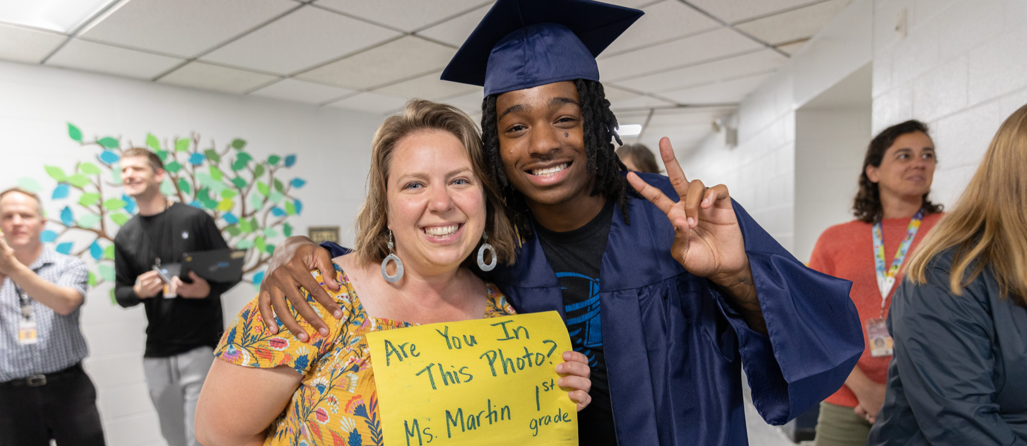 A senior and Estes Elementary teacher pose for a photo.