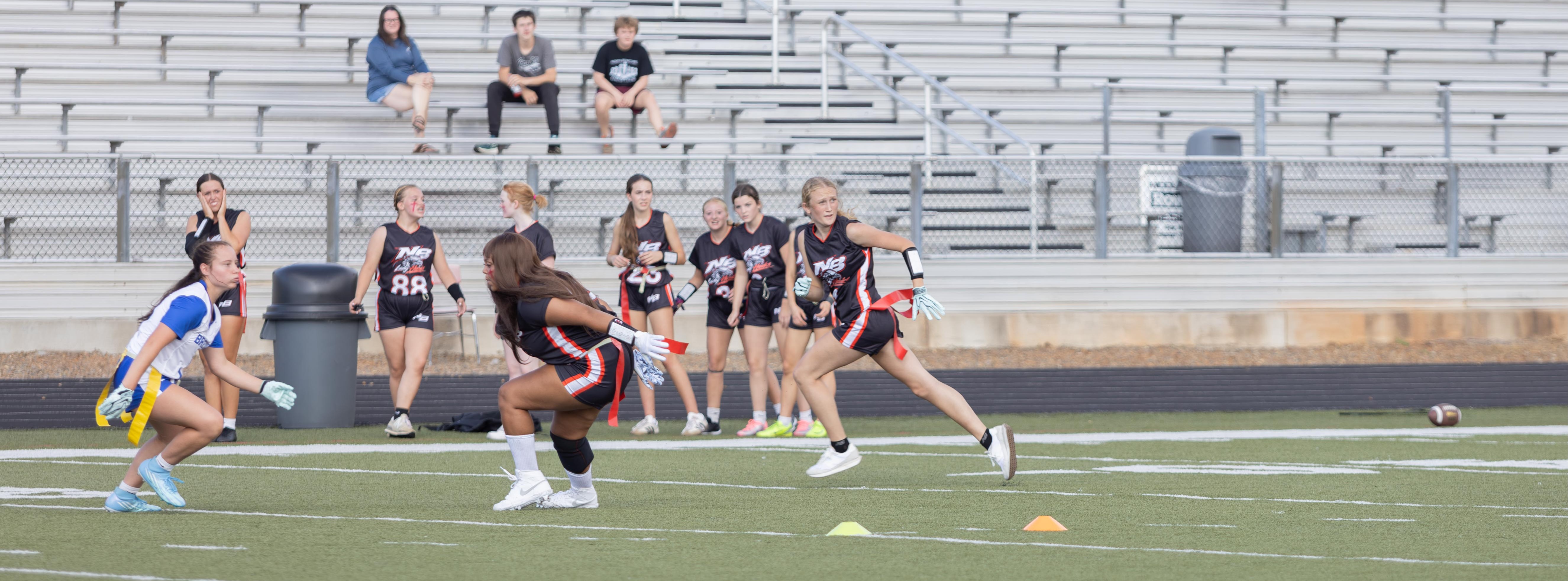 woman running with football
