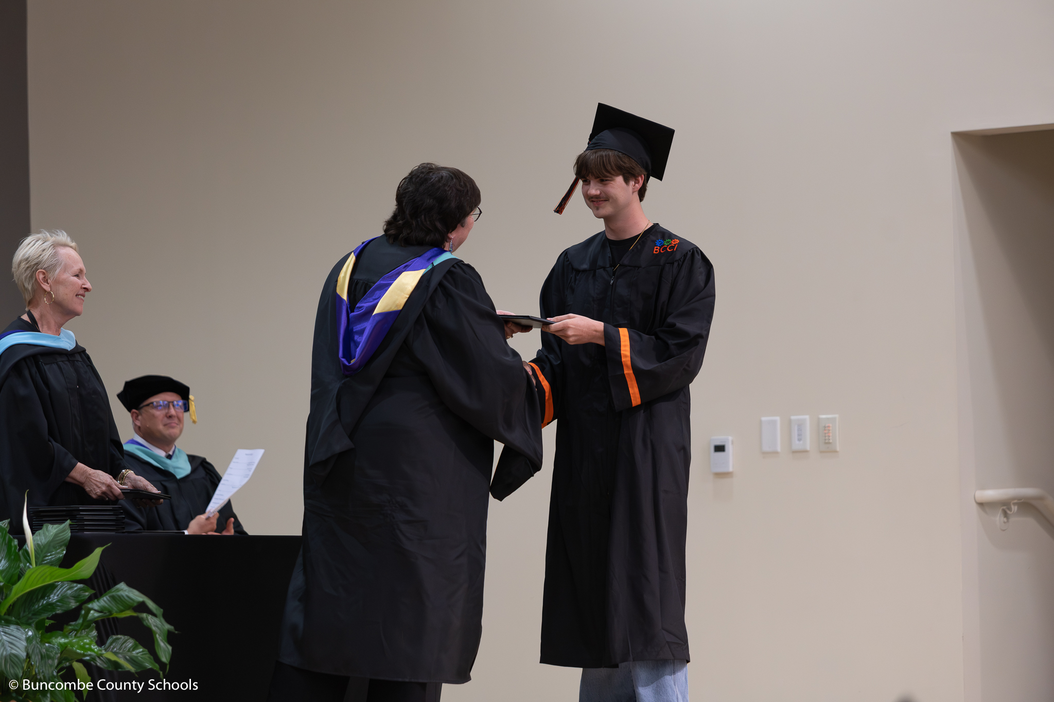 Senior walking across the stage at graduation. 
