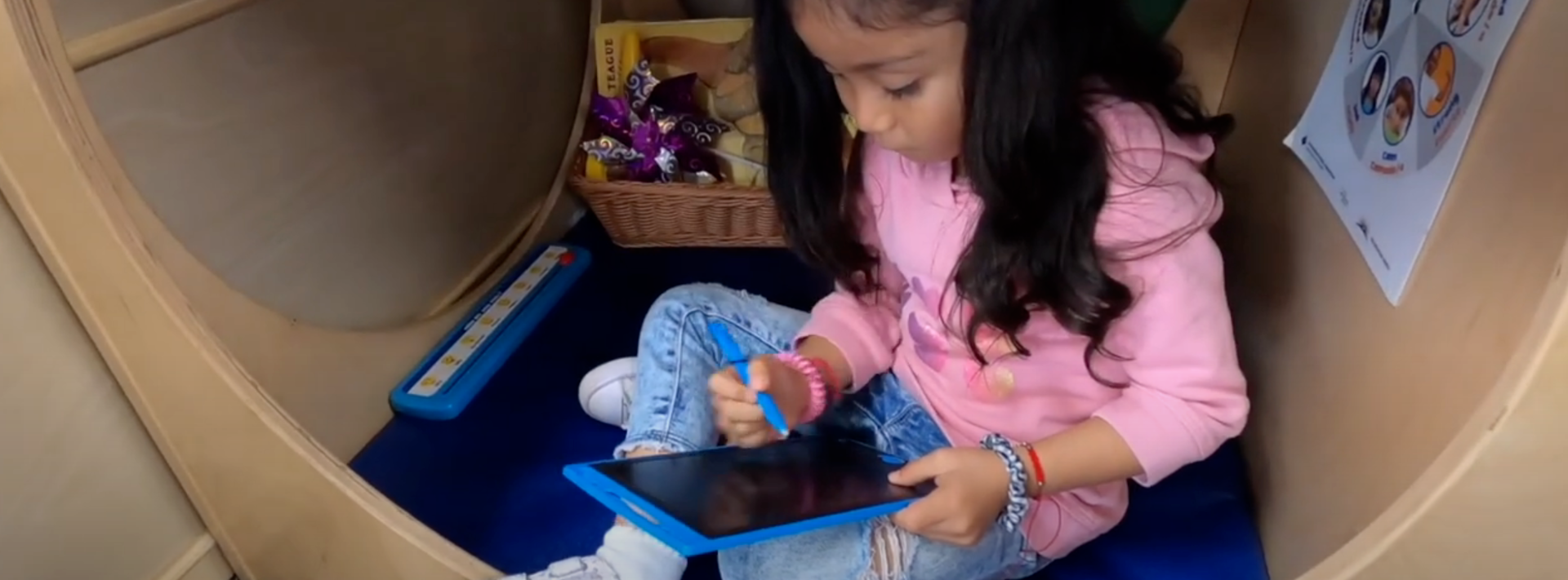 EUSD preschool student using her iPad in class.
