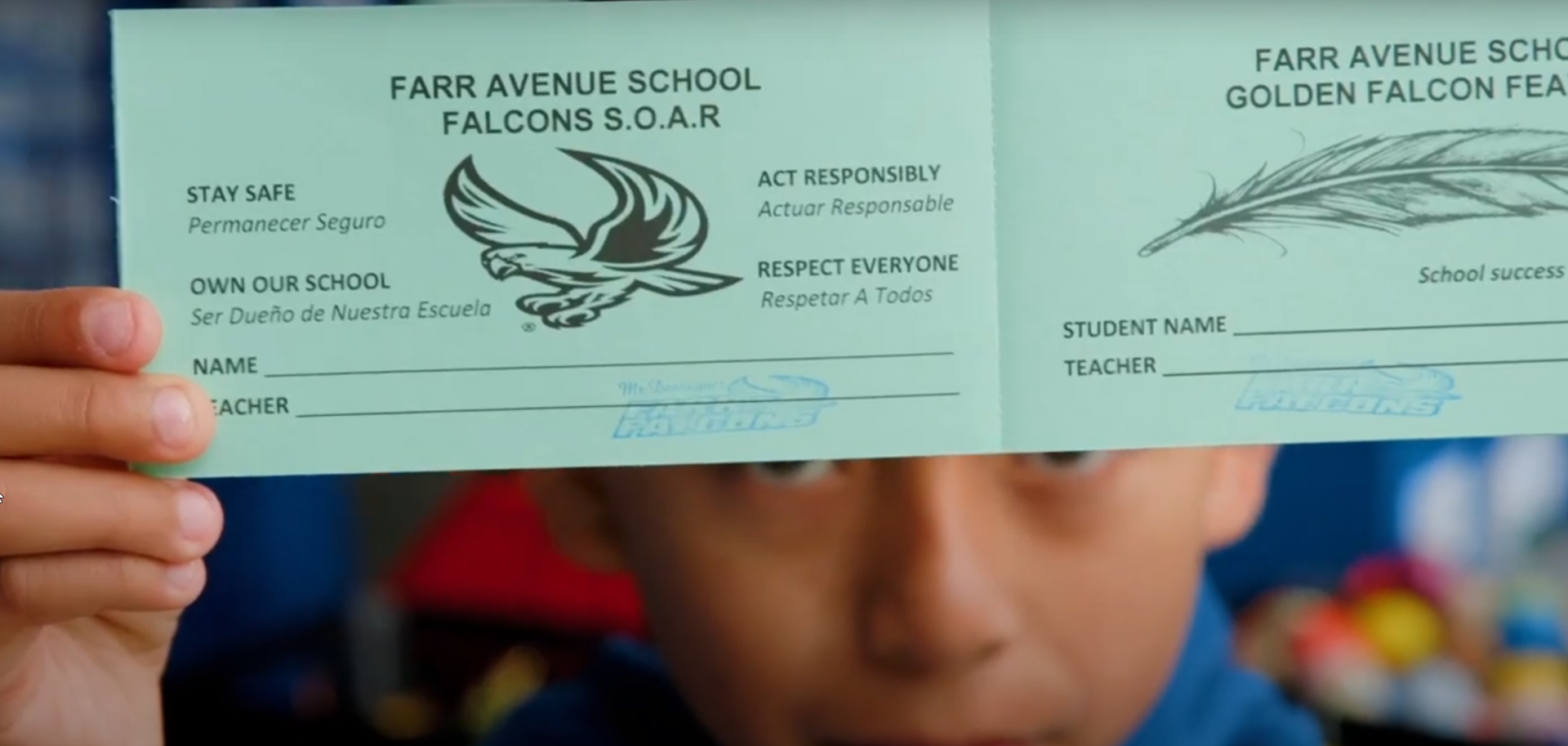 Farr student holding up a PBIS award ticket.