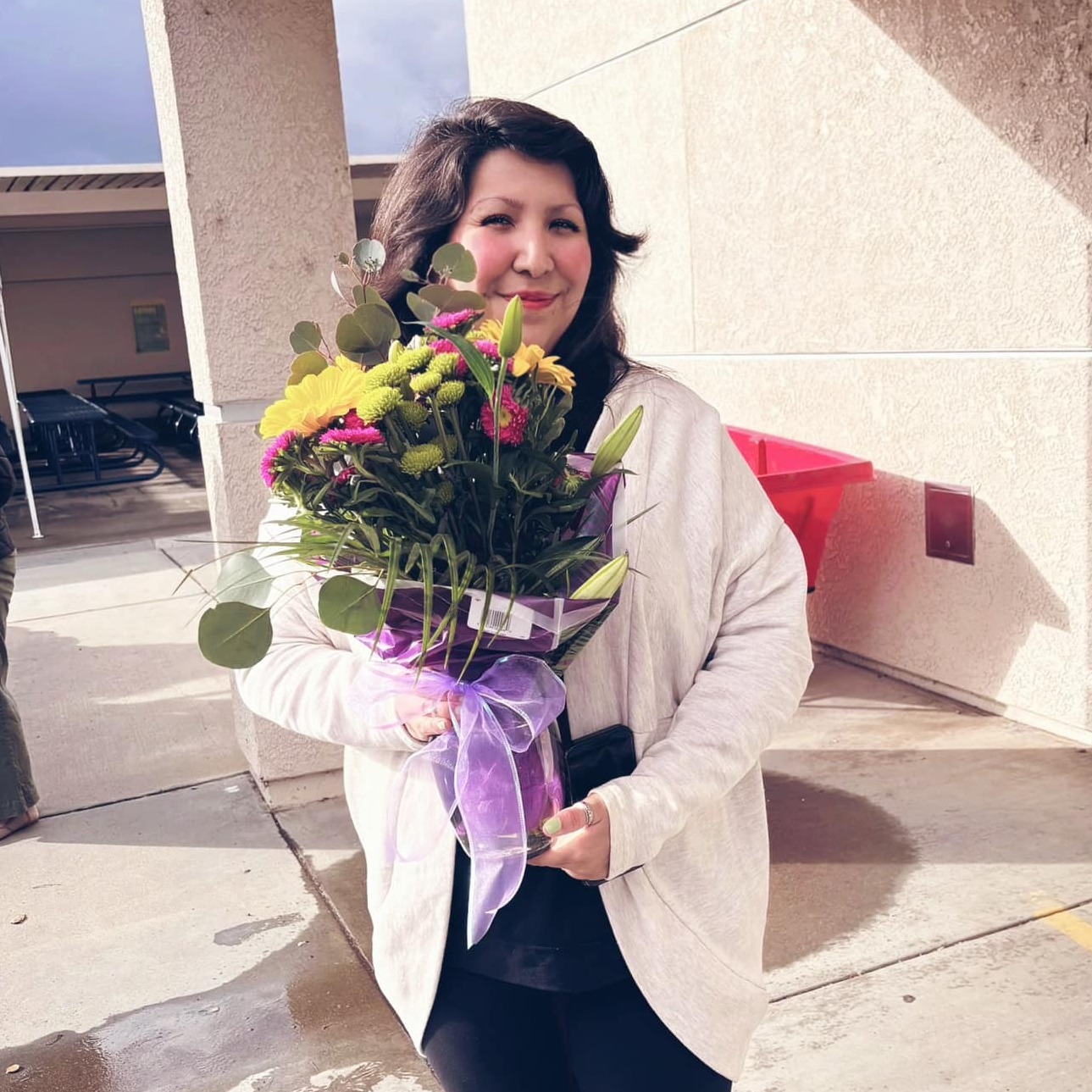 Glen View Classified employee of the year Miss Lucy holding flowers.