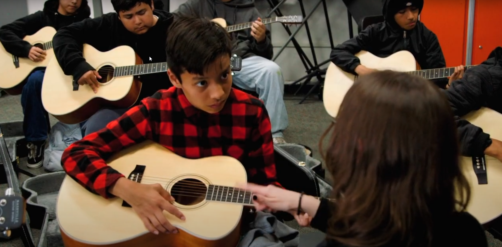 Del Dios students practicing guitar in music class.