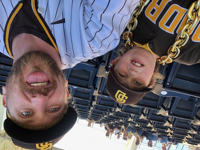 a man and boy wearing Padres clothes and making silly faces