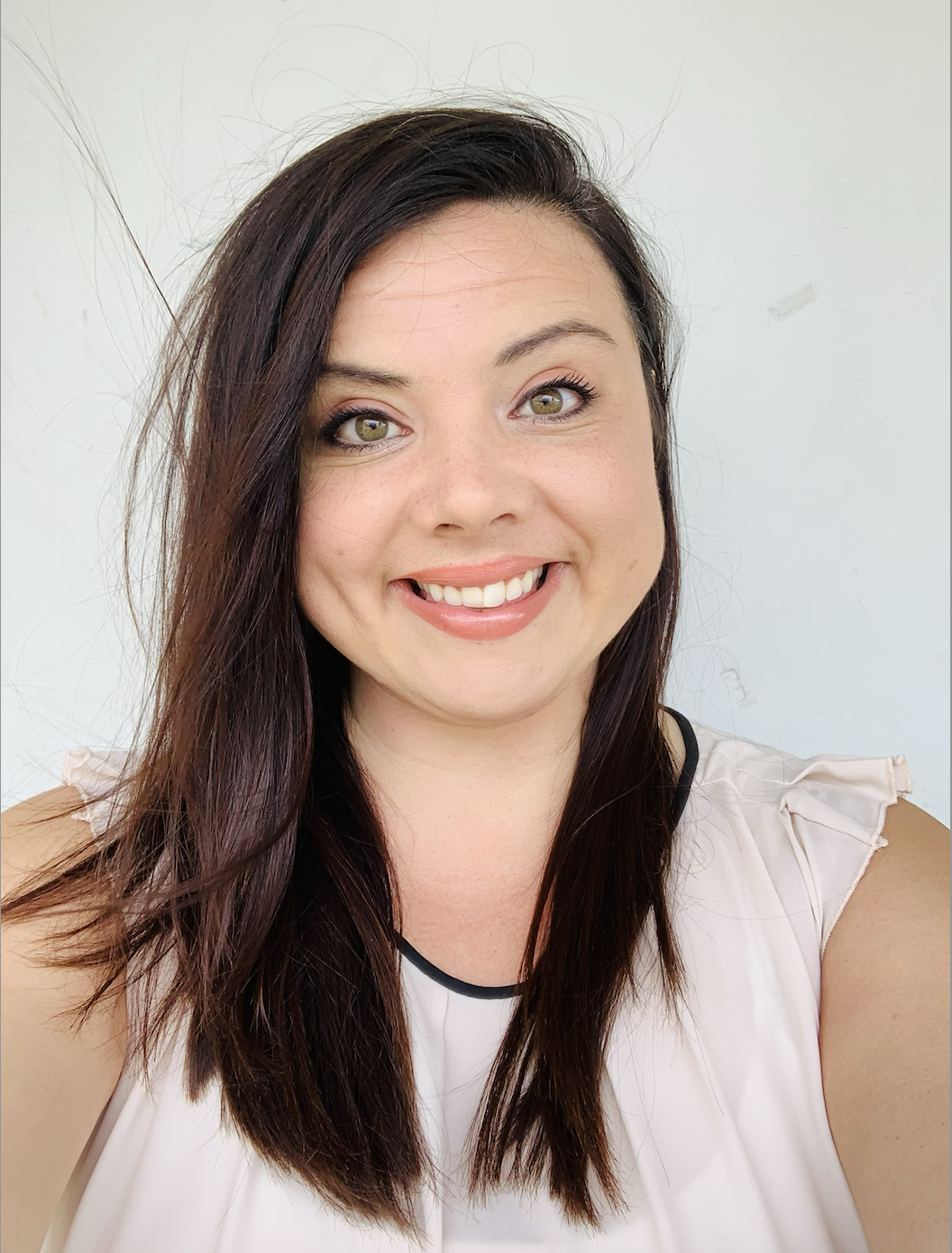 brunette woman with pink lips, white teeth, smiling