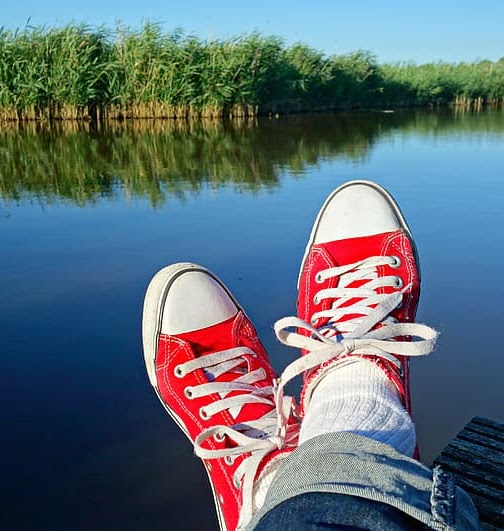 Red sneakers, lake background