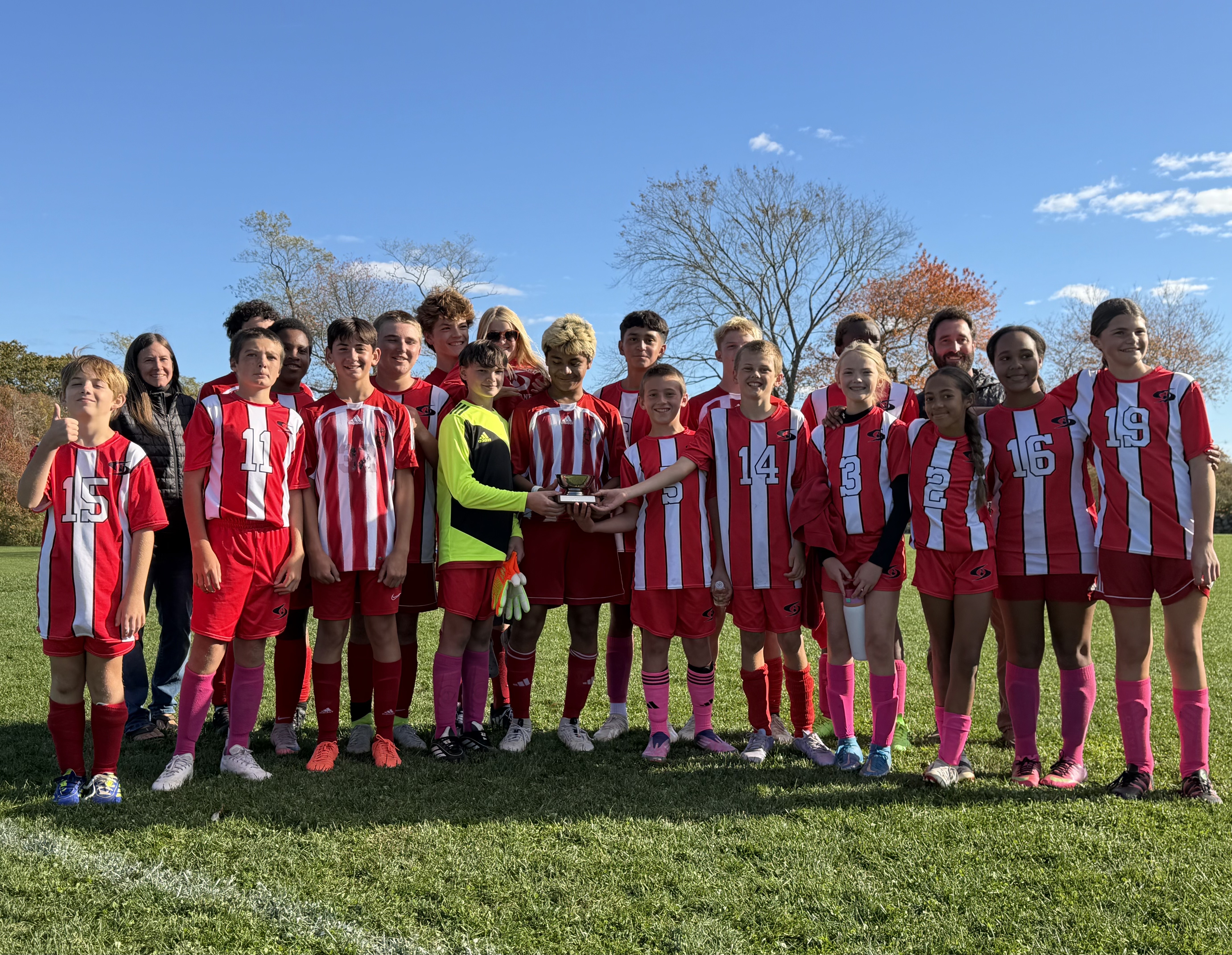 Middle School Soccer Team Holding Trophy after Winning Tournament